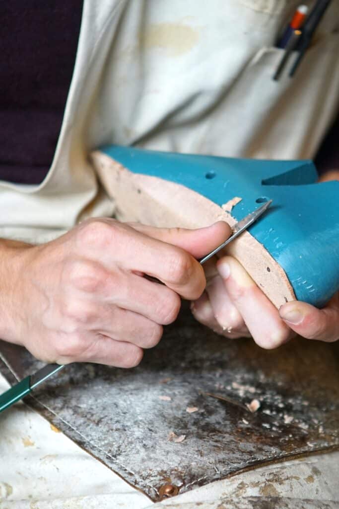 man making custom shoes