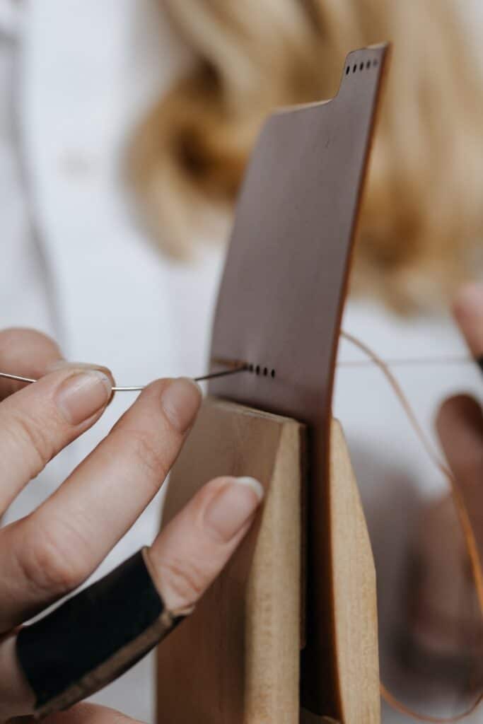 woman making handmade leather shoes